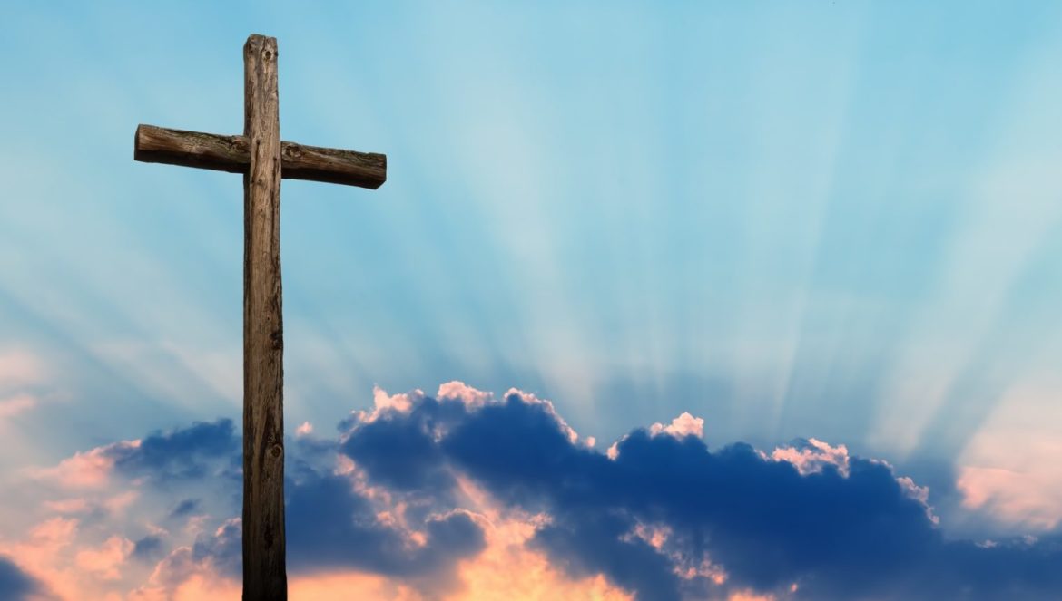 Christian cross made of wood over beautiful sky background
